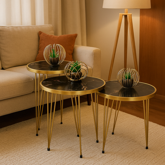 "Set of three black marble and gold metal nesting side tables with decorative plants in a cozy living room with a beige sofa and warm lighting"