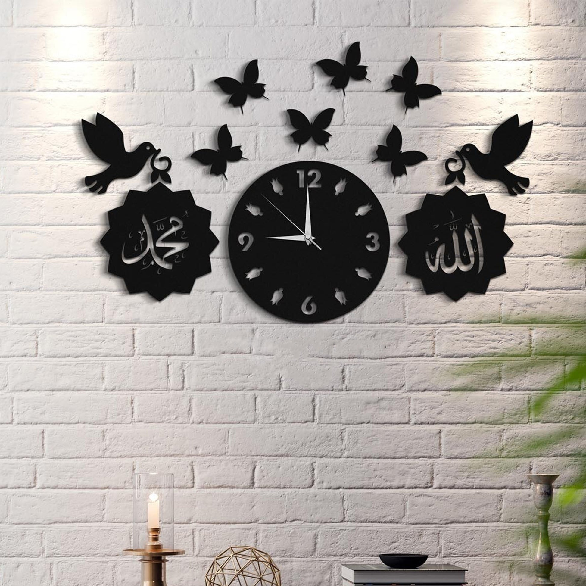 "Islamic wall clock with Arabic calligraphy, butterflies, and bird designs on a white brick wall."
