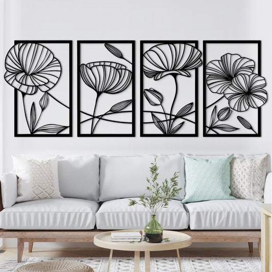 "Set of 4 black floral outline wall art panels mounted above a white sofa in a modern living room."