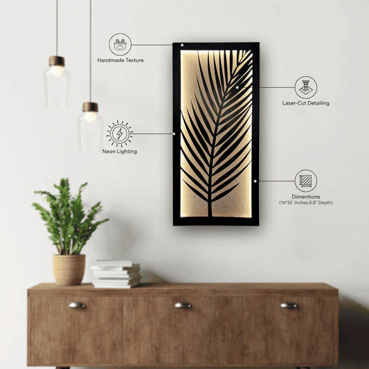 Decorative wall art with leaf design on a white wall above a wooden cabinet.
