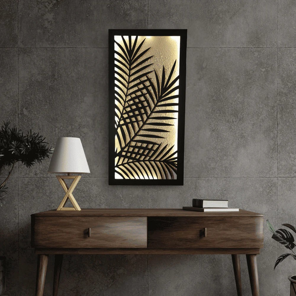 Decorative wall art with palm leaf design on a gray wall above a wooden console table.