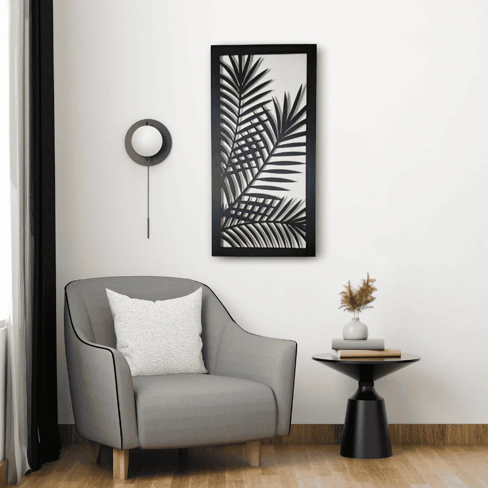 Modern interior with a gray armchair, side table, and framed leaf print on the wall.
