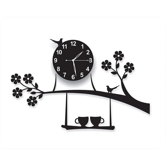 "Black wall clock with tree branch design, birds, flowers, and two teacups on a swing platform."