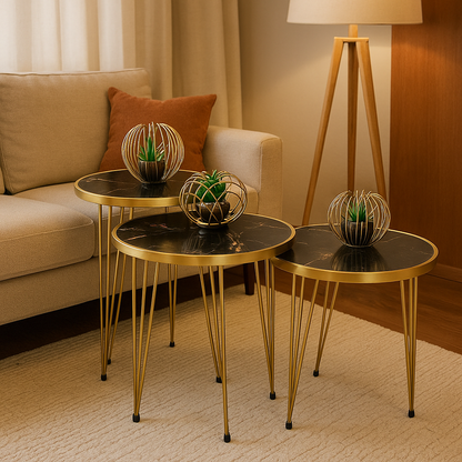"Set of three black marble and gold metal nesting side tables with decorative plants in a cozy living room with a beige sofa and warm lighting"