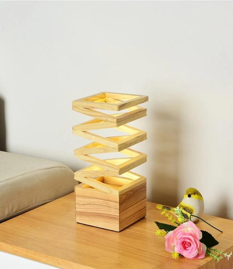 Modern spiral wooden LED table lamp with natural wood finish, placed on a wooden side table beside a flower and decorative bird.