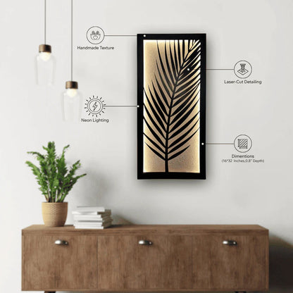 Decorative wall art with leaf design on a white wall above a wooden cabinet.
