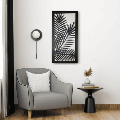 Modern interior with a gray armchair, side table, and framed leaf print on the wall.